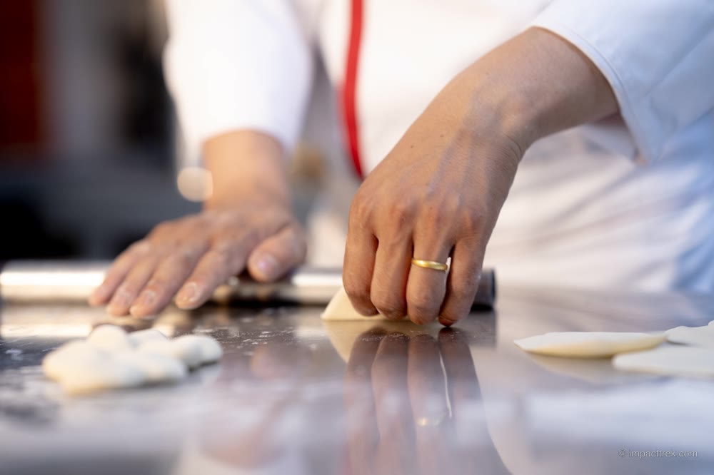 Rolling thin momo wrappers by hand in the café kitchen